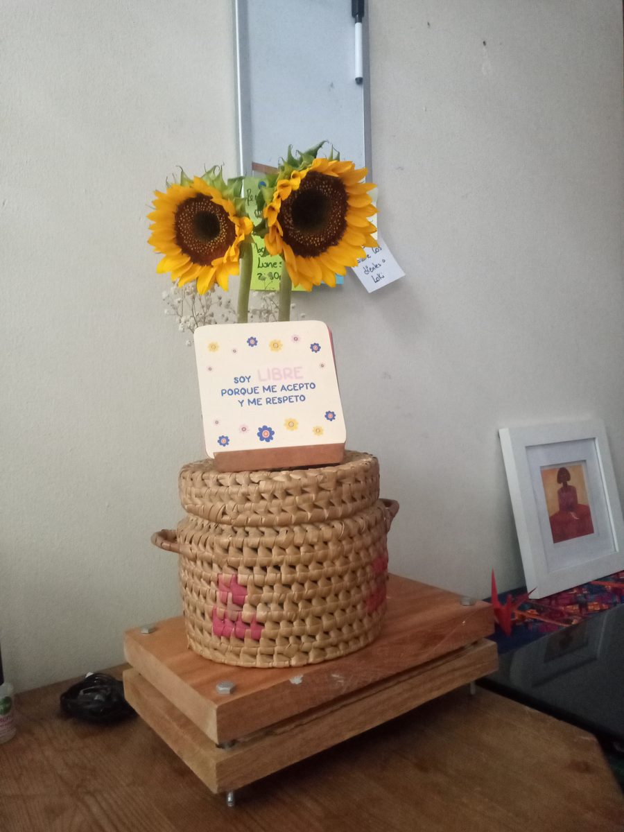 An affirmation card next to sunflowers